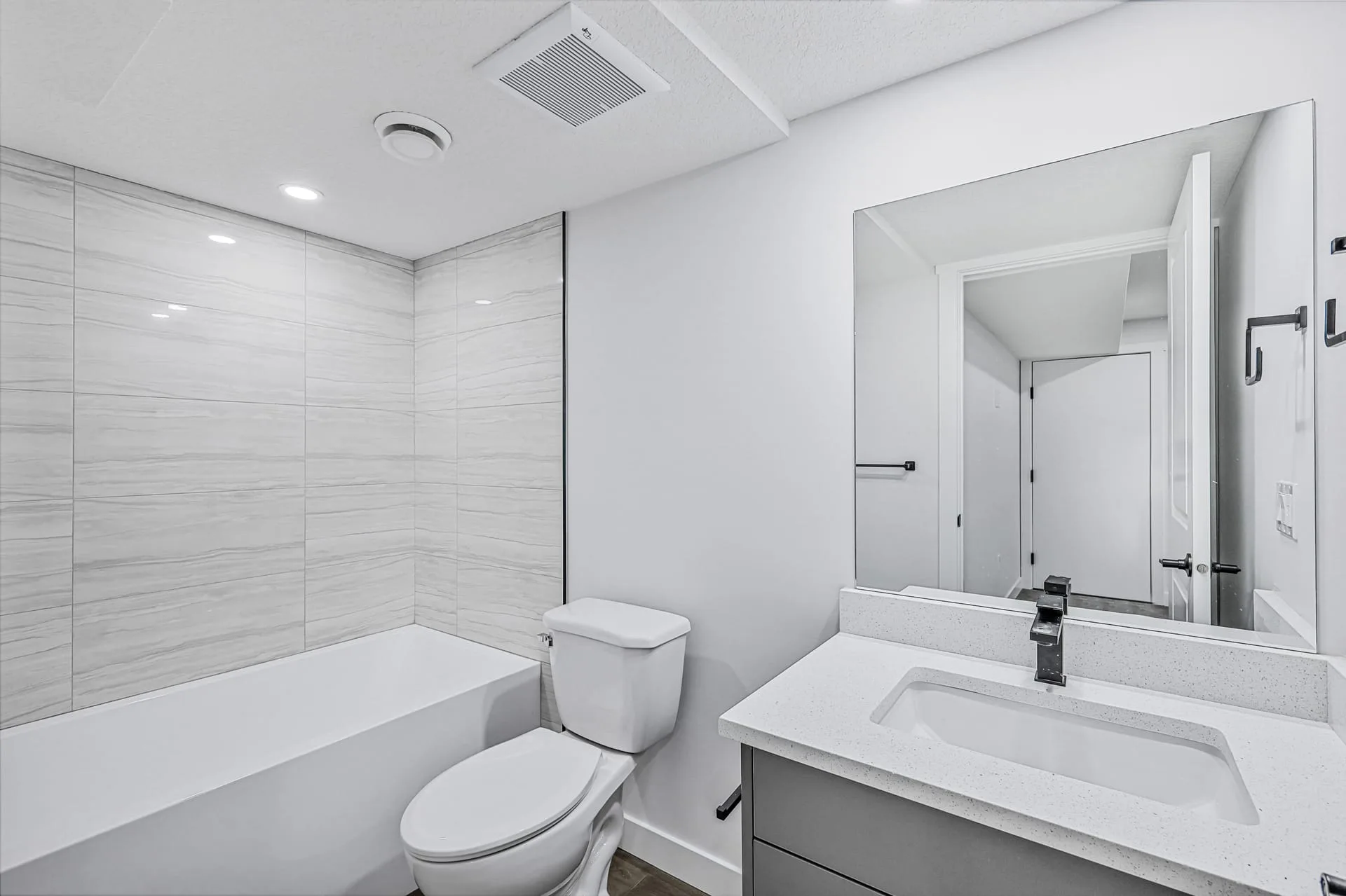 Legal suite kitchen with white cabinetry completed by OAF Construction