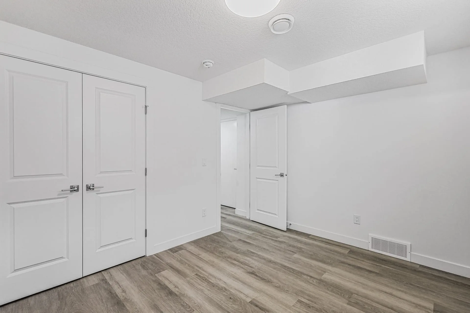 Calgary legal suite entrance and finished hallway by OAF Construction